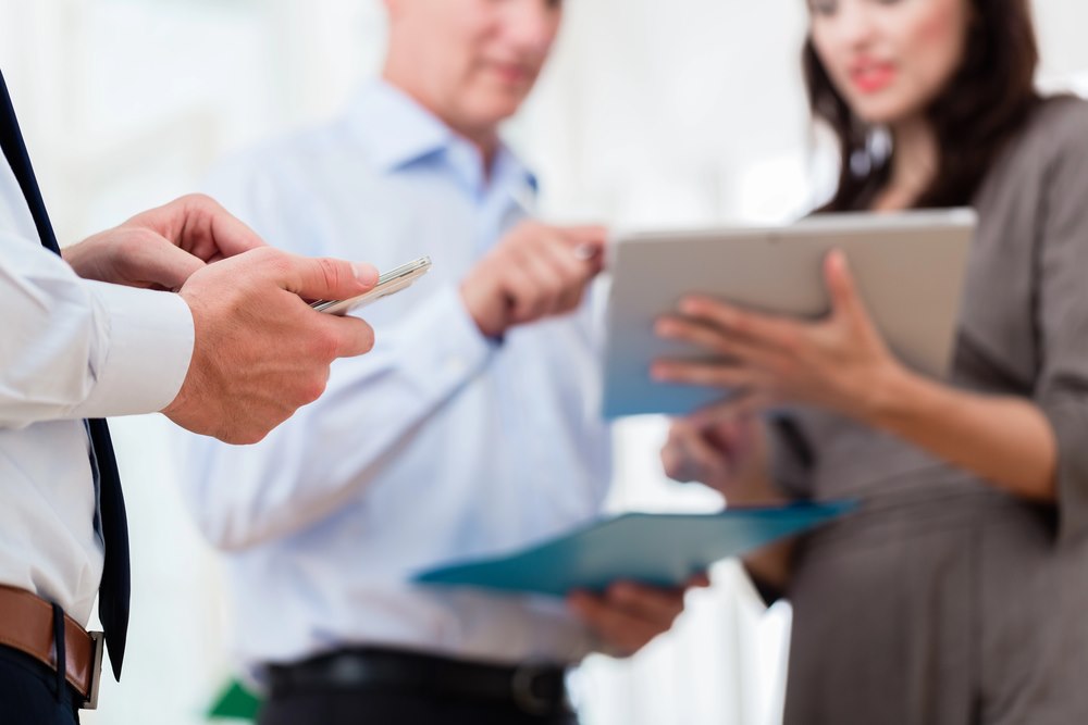 Business people in an office during a short presentation, featuring 411 Business Law, highlighting Financial Integration and Reporting, and aligning with the page's context.